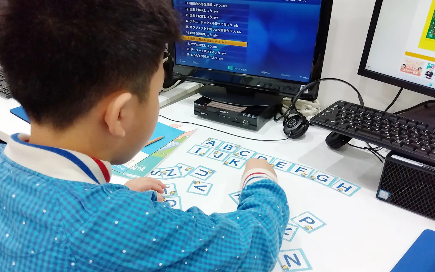 竜ヶ崎教室でアルファベット学習に取り組む小学生