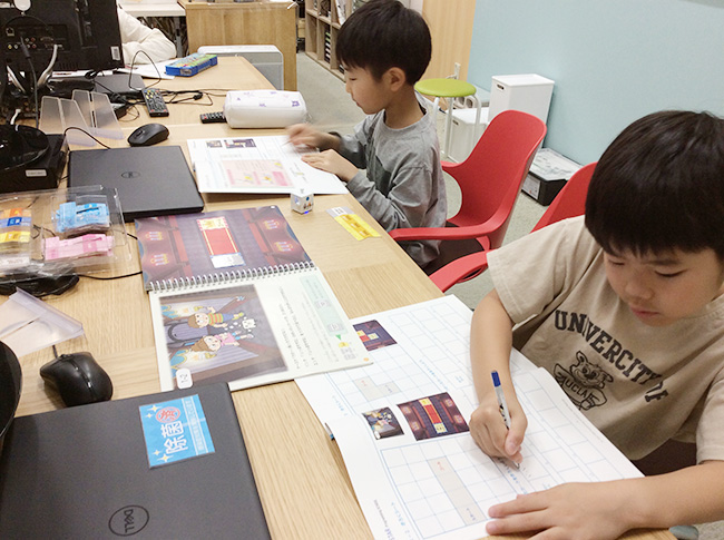 教科書に記録する子供たち