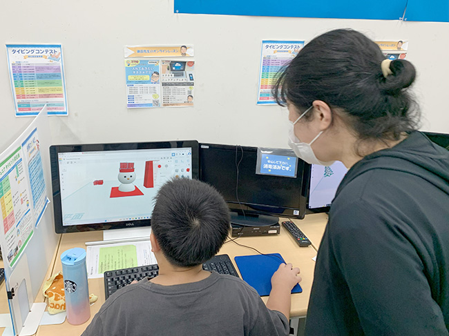 教室の先生に見守られながら3D作成する受講生